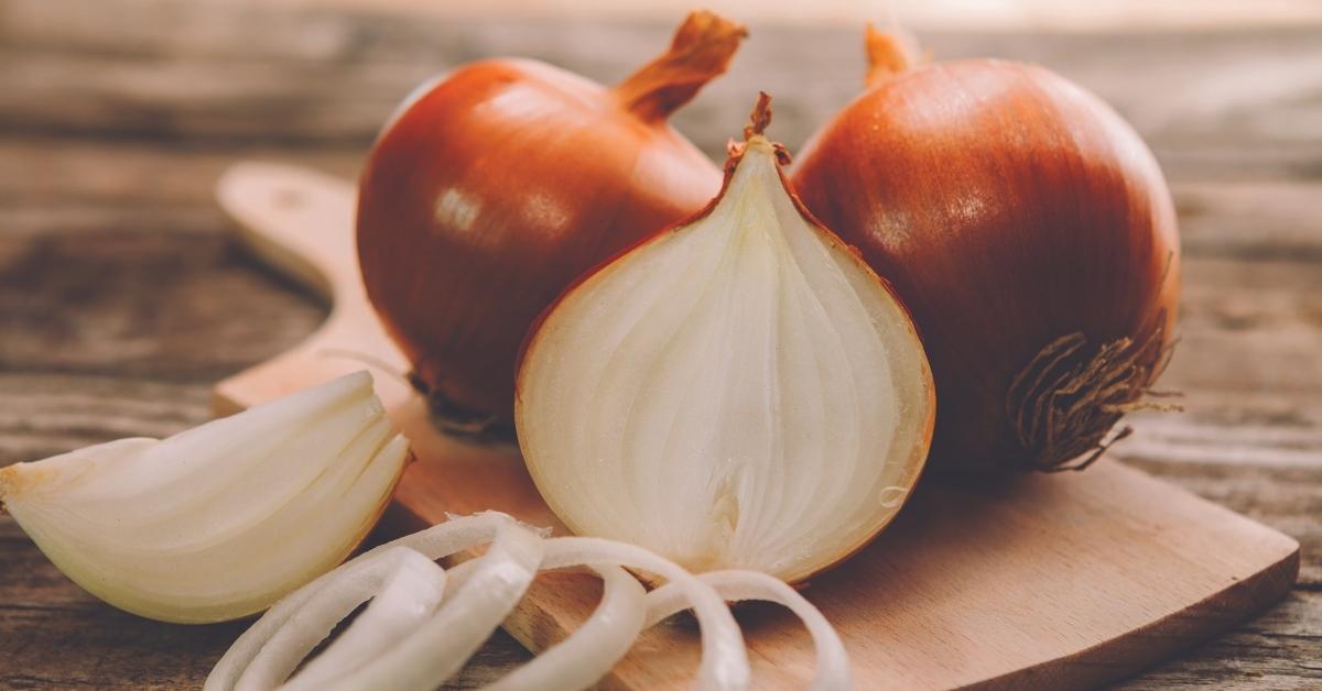Onion 'Setton' on a chopping board, from our pick of the best vegetable varieties.