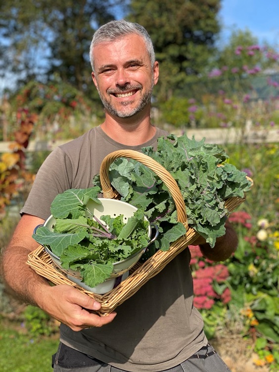 Dobies new vegetable seed range 2023 includes this new Kale 'cottagers' variety pictured as harvested leaves in a basket that's being held by Rob Smith