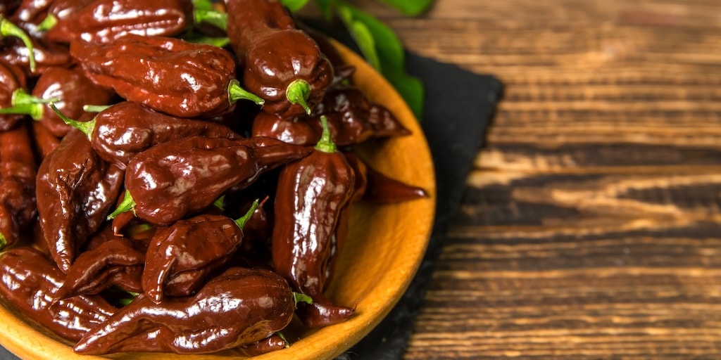 Wooden bowl full of brown chocolate habanero chilli