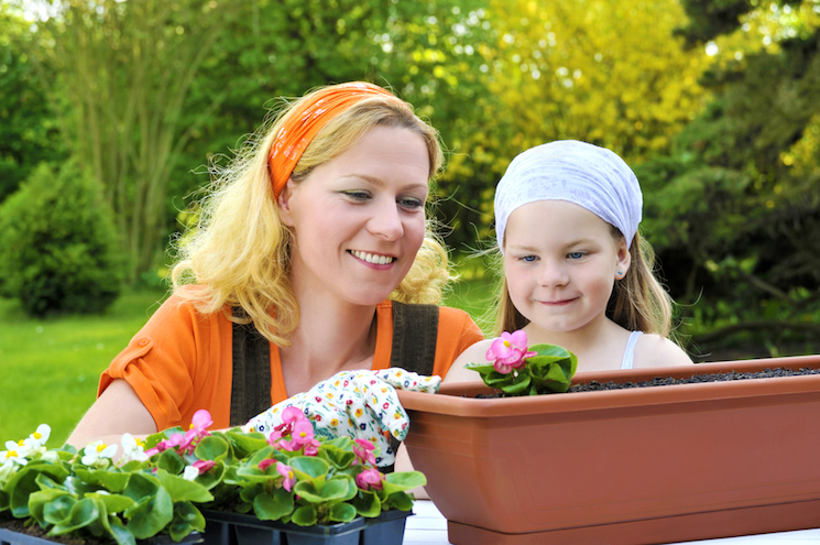 woman and child planting out plug plants